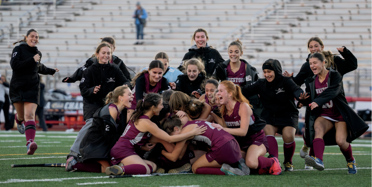 Emotional ending: The girls’ varsity field hockey team rushes toward senior, co-captain and midfielder Shae Wozniak after she scores the winning goal in the PIAA 3A State Championship. On Nov. 16, the girls won 2-1 against Villa Maria in an overtime period. 